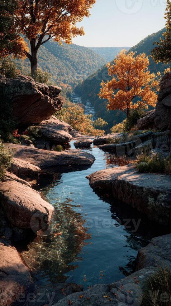 Vibrant autumn landscape featuring a serene stream winding through rocky terrain in a forested valley photo