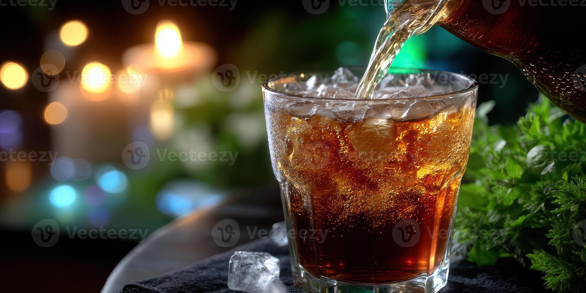 Refreshing beverage served over ice with sparkling bubbles amidst warm candlelight setting photo