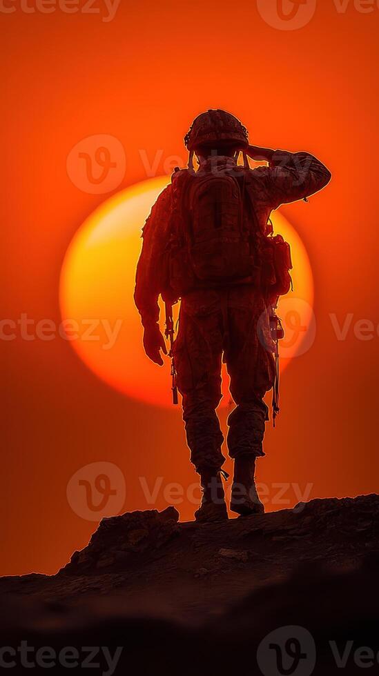 Soldier saluting against a vibrant sunset in a moment of reflection and honor at the edge of the horizon photo