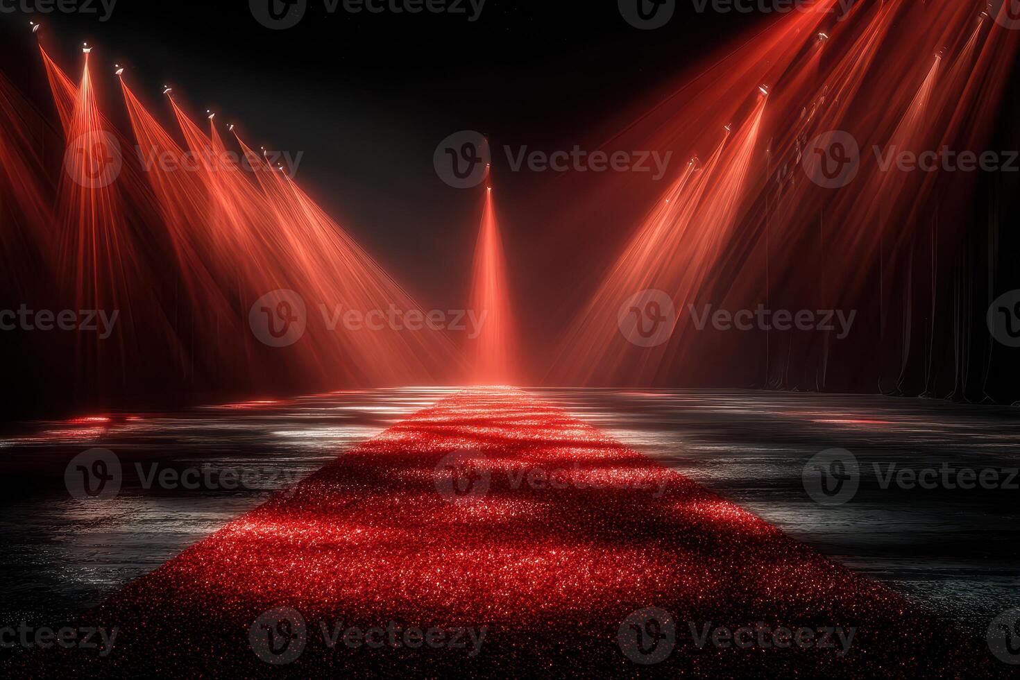 Dramatic red carpet illuminated by spotlight beams at a glamorous event in a darkened venue photo
