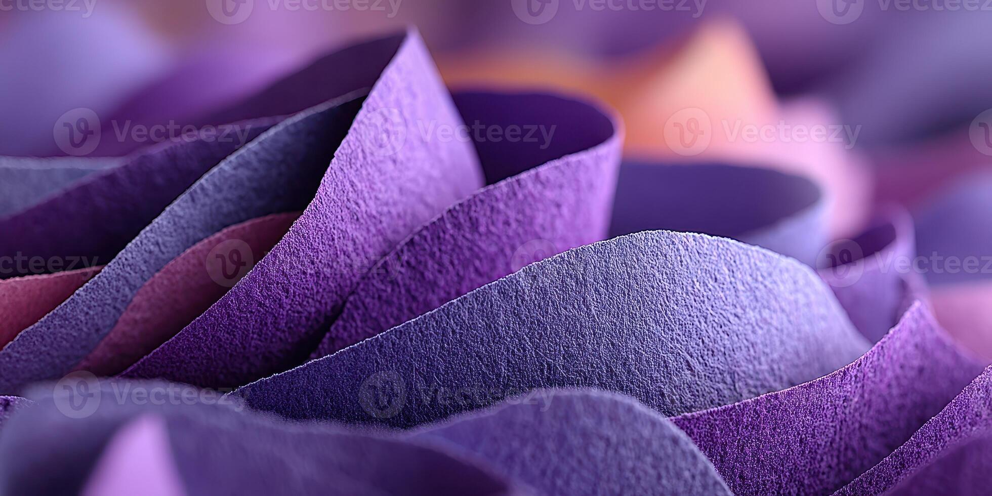 Beautiful arrangement of textured purple paper creating a vibrant wave pattern in a close-up view photo