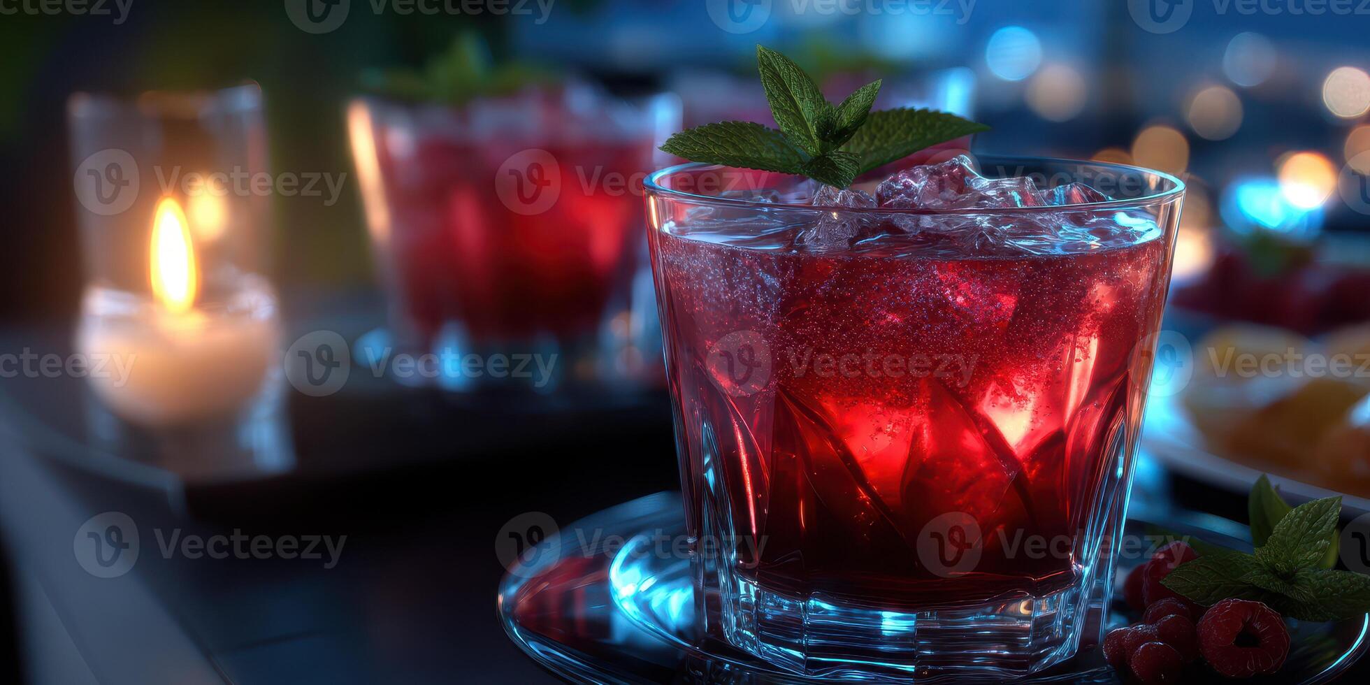 Refreshing cocktails served in elegant glasses with vibrant red colors during a night gathering in a city photo