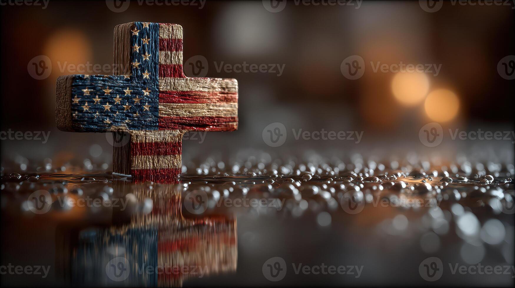 Decorative wooden cross with American flag design on wet surface with bokeh lights in background photo