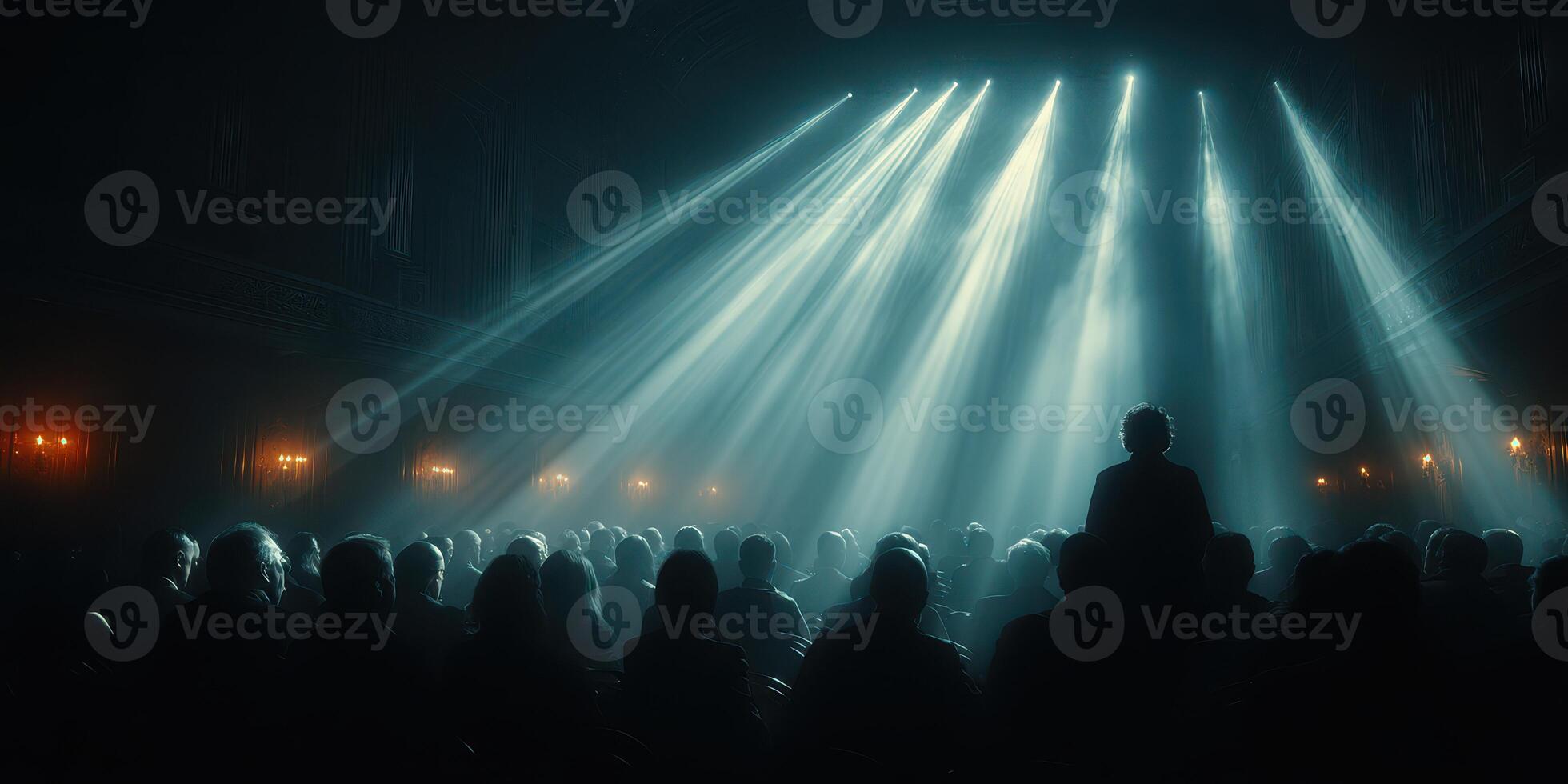 People enjoying a theatrical performance in a dimly lit venue with spotlight beams illuminating the stage photo
