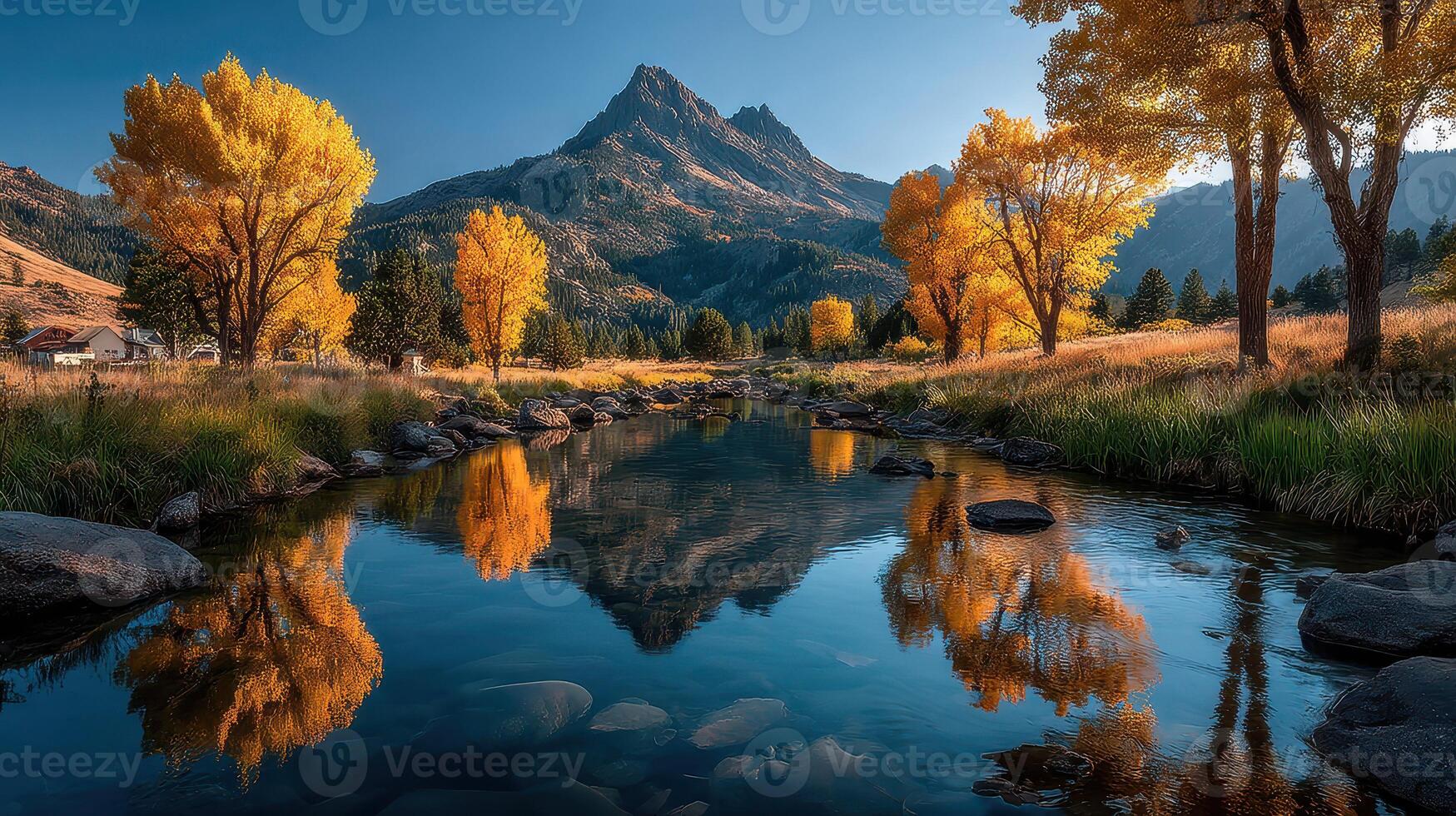 Colorful autumn landscape with trees and mountain reflected in tranquil stream during golden hour photo