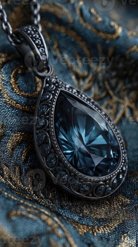 Elegant teardrop pendant resting on richly patterned fabric with intricate design details in a soft lighting environment photo