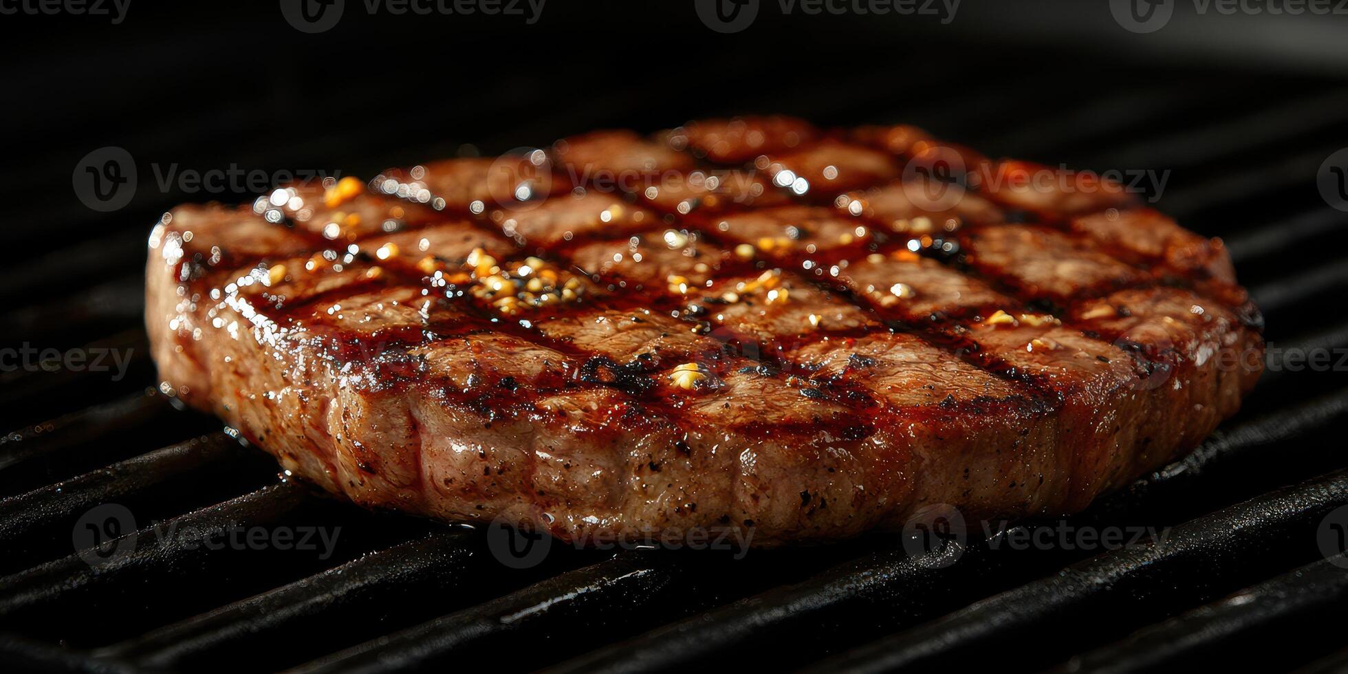 Juicy grilled steak searing on a barbecue grill creating perfect markings and flavor enhancement photo