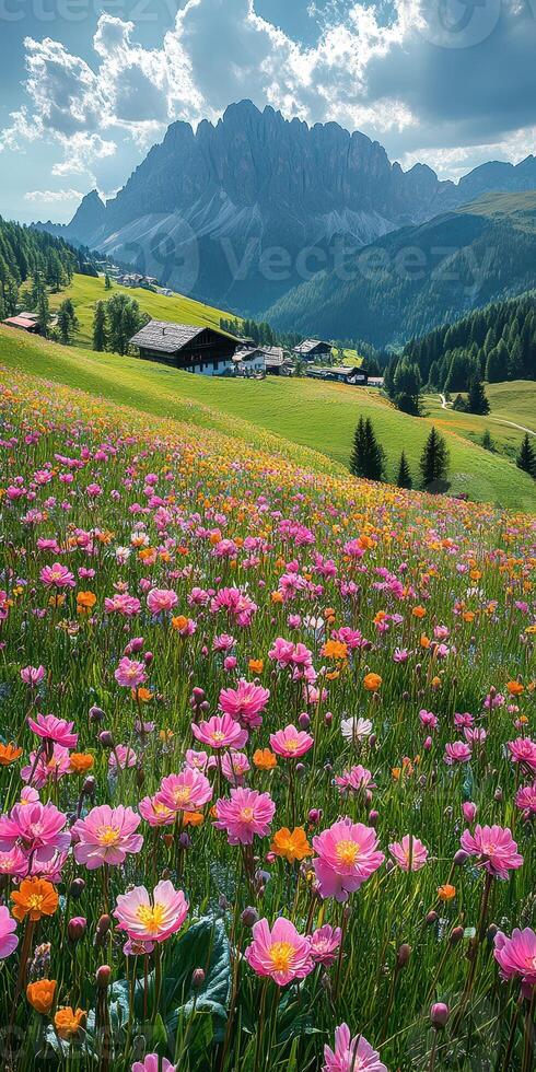 Colorful wildflowers bloom in a lush valley with towering mountains and a quaint village under a partly cloudy sky photo