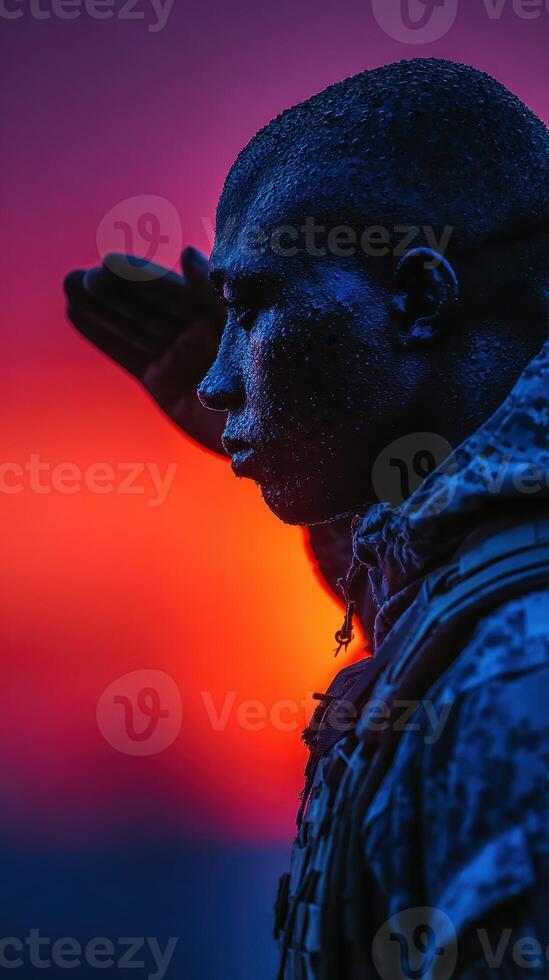 Soldier saluting at sunset with a dramatic sky background in a moment of respect and reflection photo