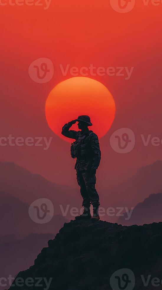 Soldier salutes against a stunning sunset backdrop in a mountainous landscape, highlighting bravery and honor photo