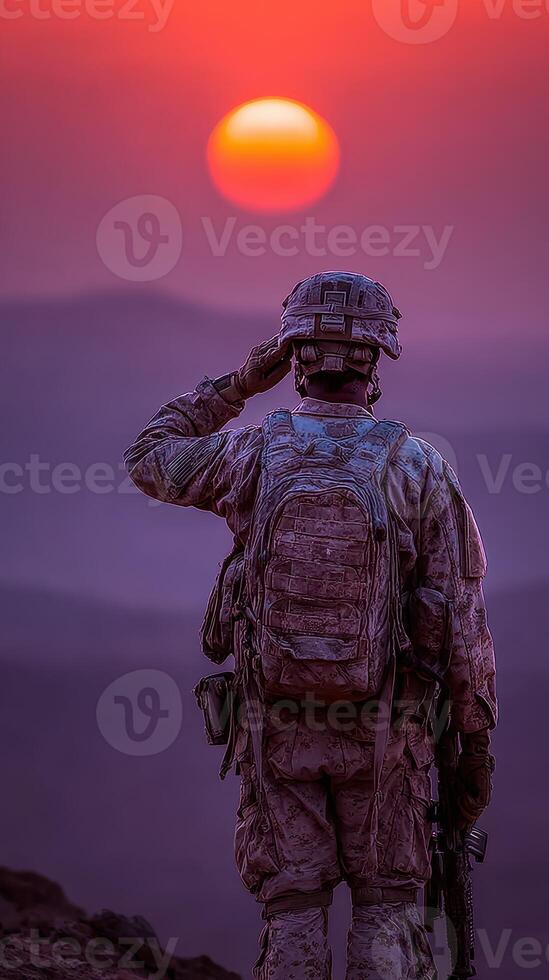 Soldier salutes at sunset over a mountain landscape in a moment of reflection and honor during a military operation photo