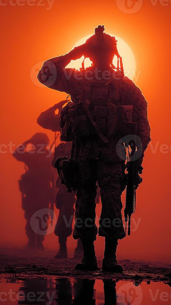 Soldiers saluting at sunset during a training exercise in arid terrain photo