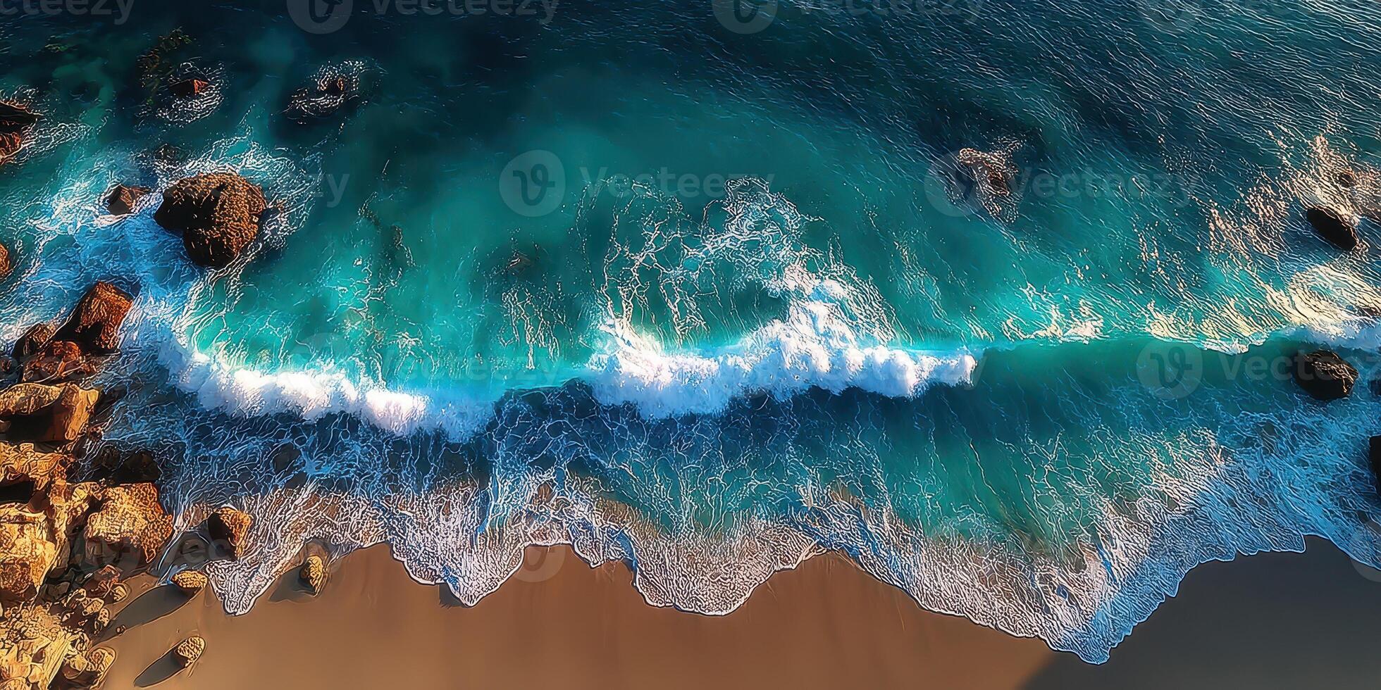 Waves crashing onto golden sandy beach with rocky formations under bright sunlight photo