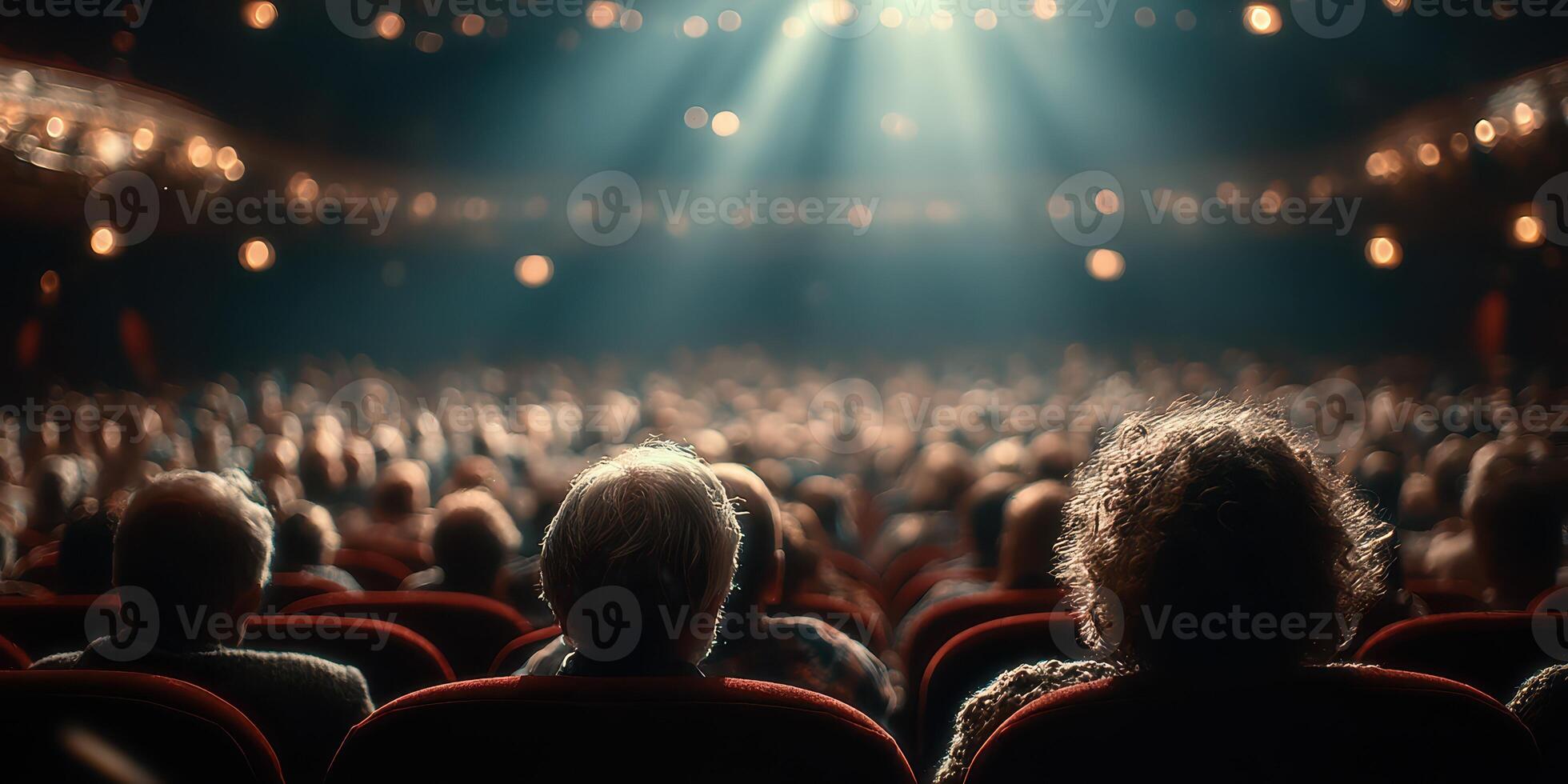 Audience enjoying a live performance at a theater during an evening show with dramatic lighting and ambiance photo