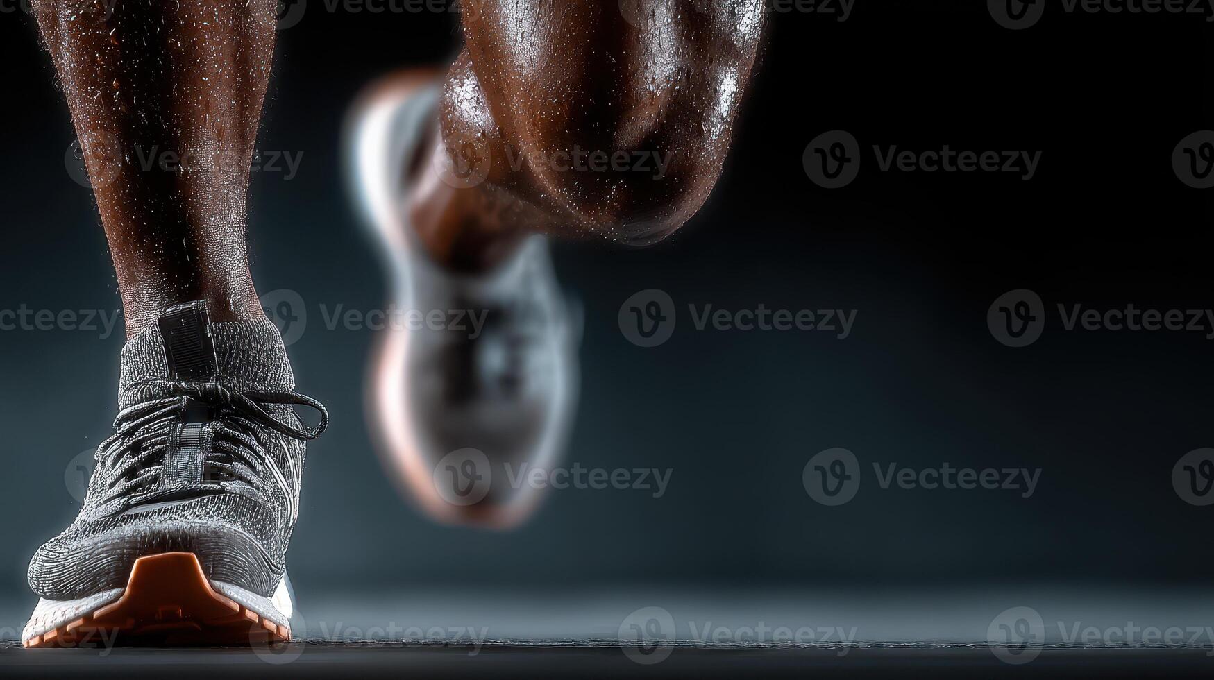 Runner in motion showcasing athletic footwear with a focus on detailed leg muscles in a dark setting photo