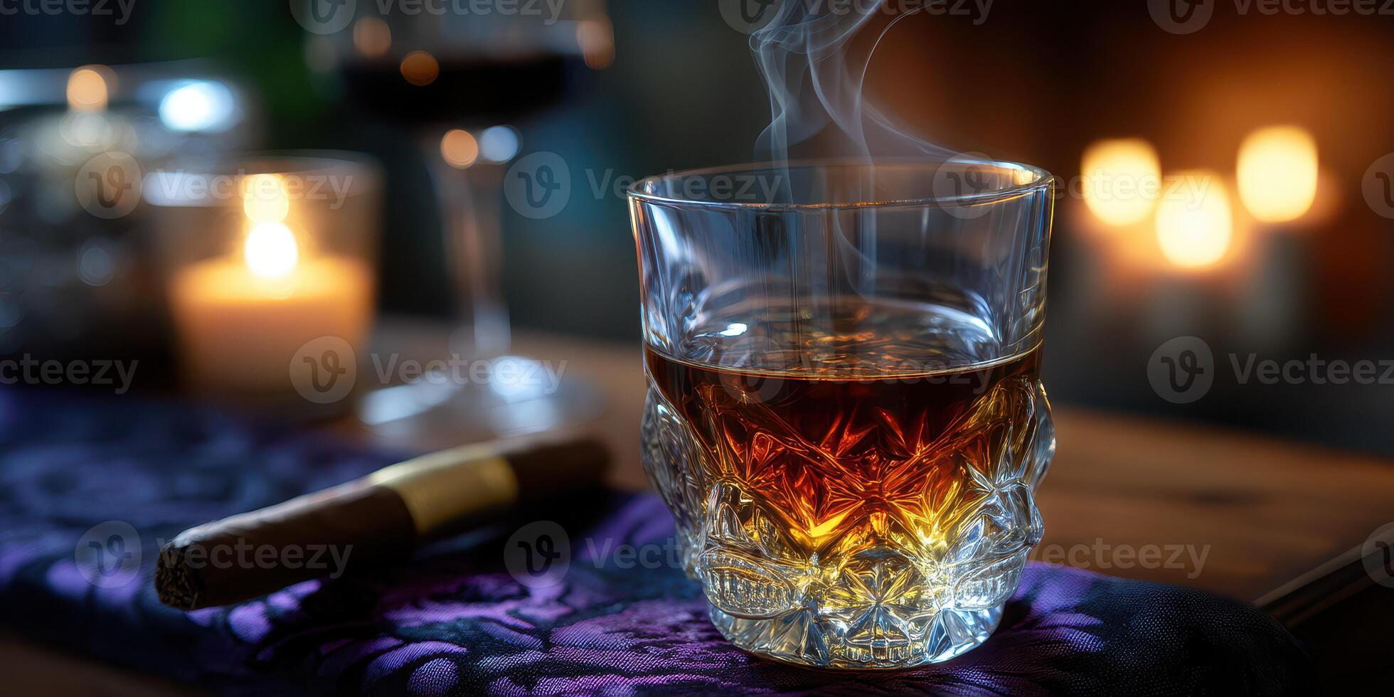 Whiskey glass with smoke on a table decorated with a cigar and candles at a cozy evening gathering photo