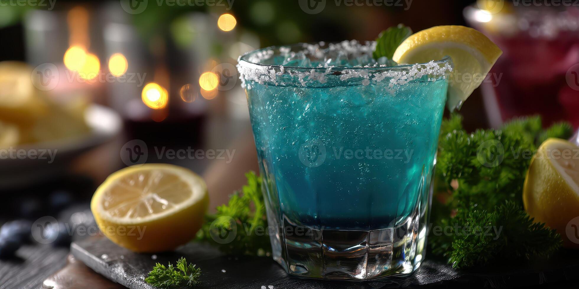 Bright blue cocktail served with lemon and garnished with mint at a vibrant gathering during a summer evening photo