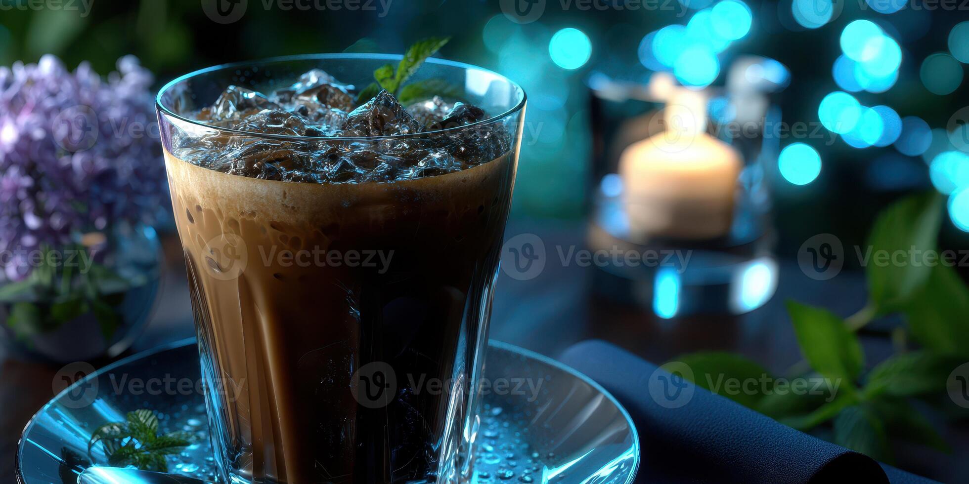 Delicious iced coffee drink served in a glass with mint leaves on a table with blue background lights photo