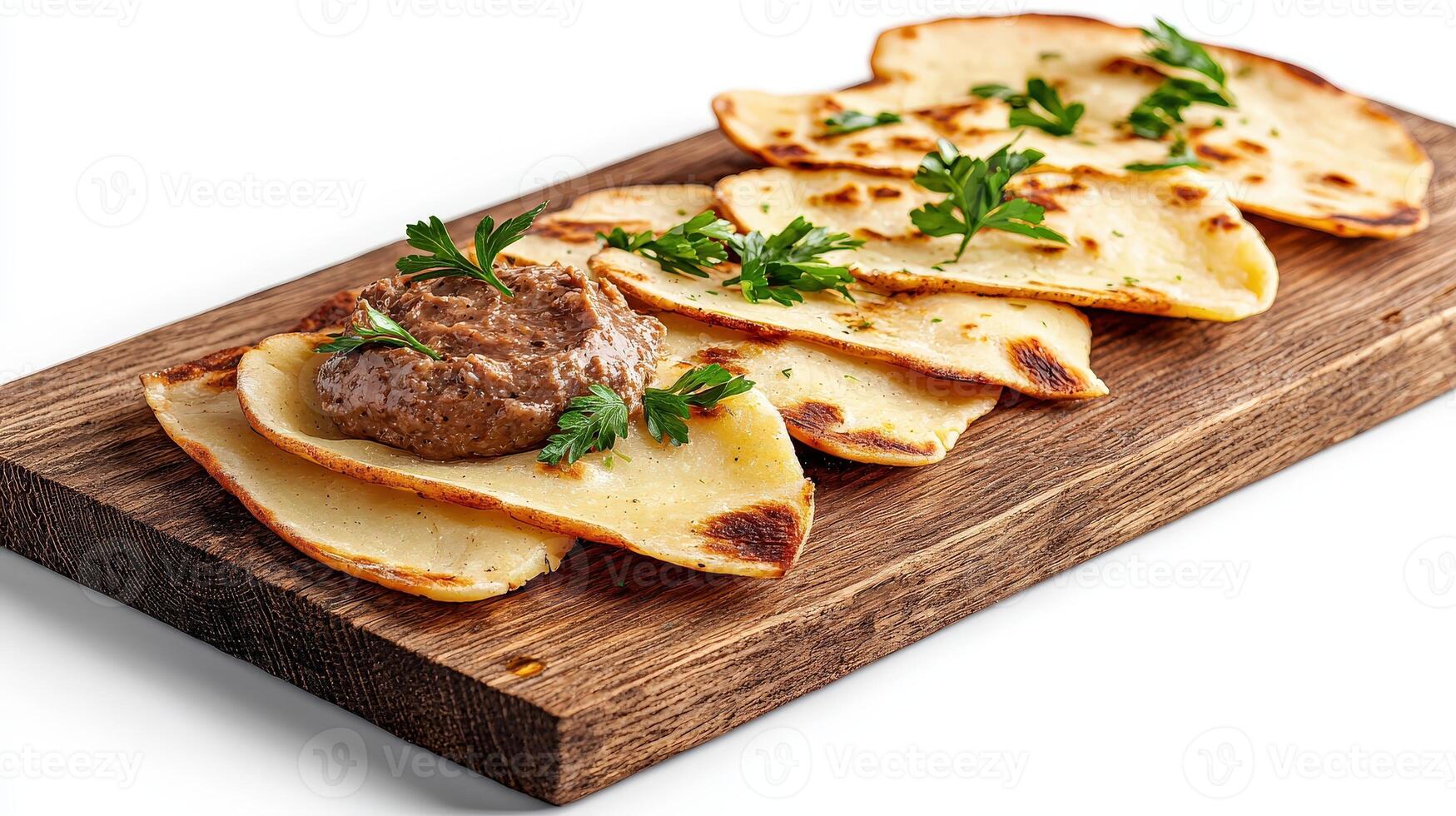 A wooden board topped with a plate of food photo