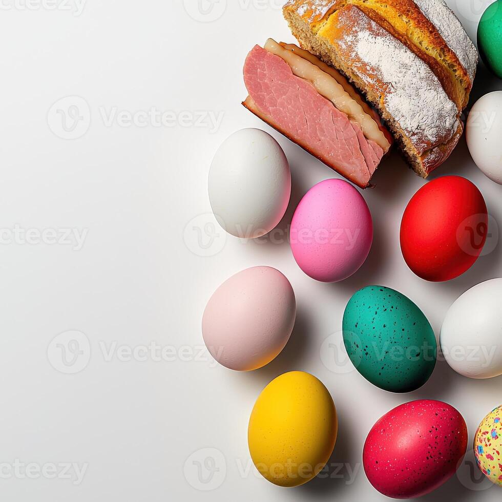 A bunch of colorful easter eggs and a loaf of bread photo