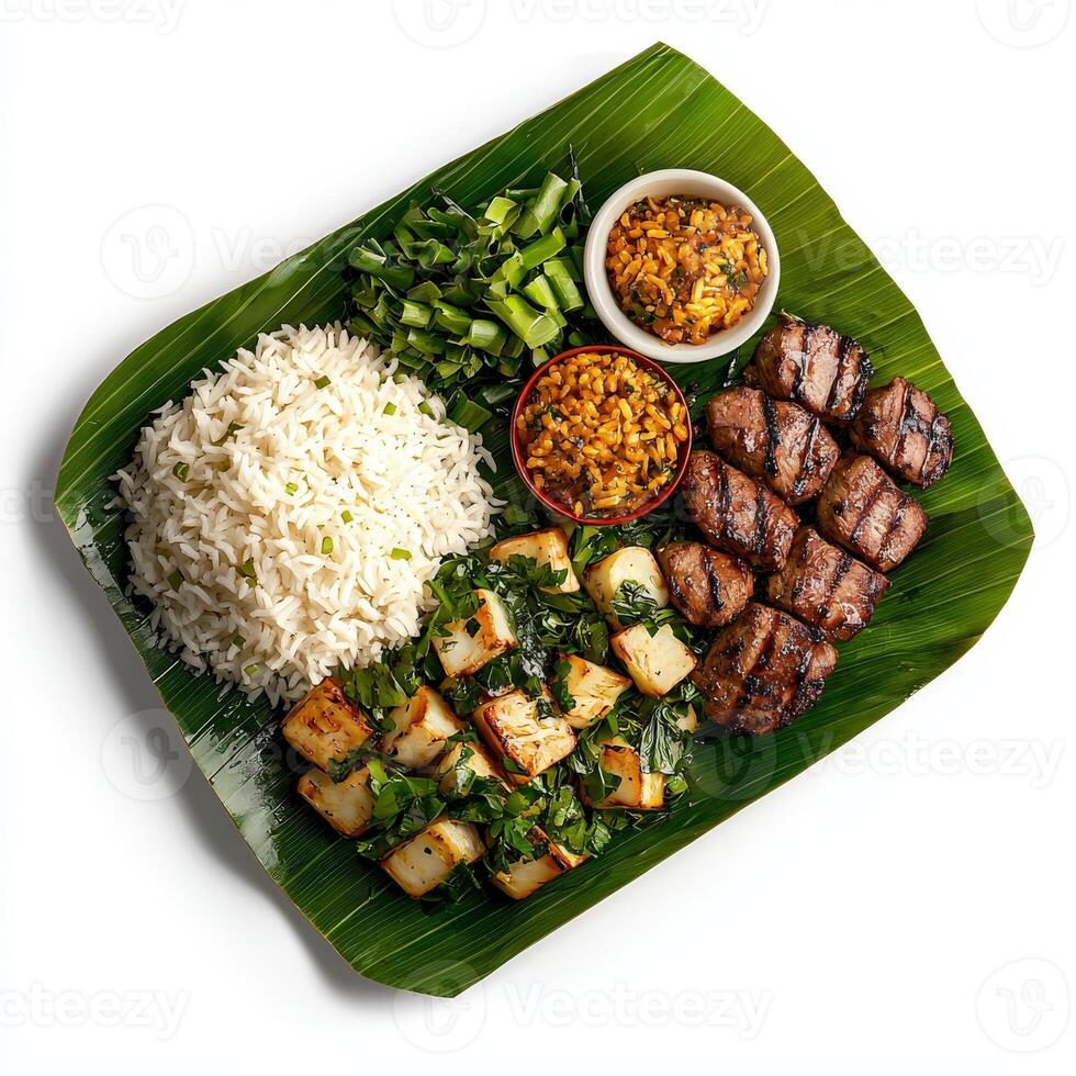 A plate with rice, meat and vegetables on a leaf photo