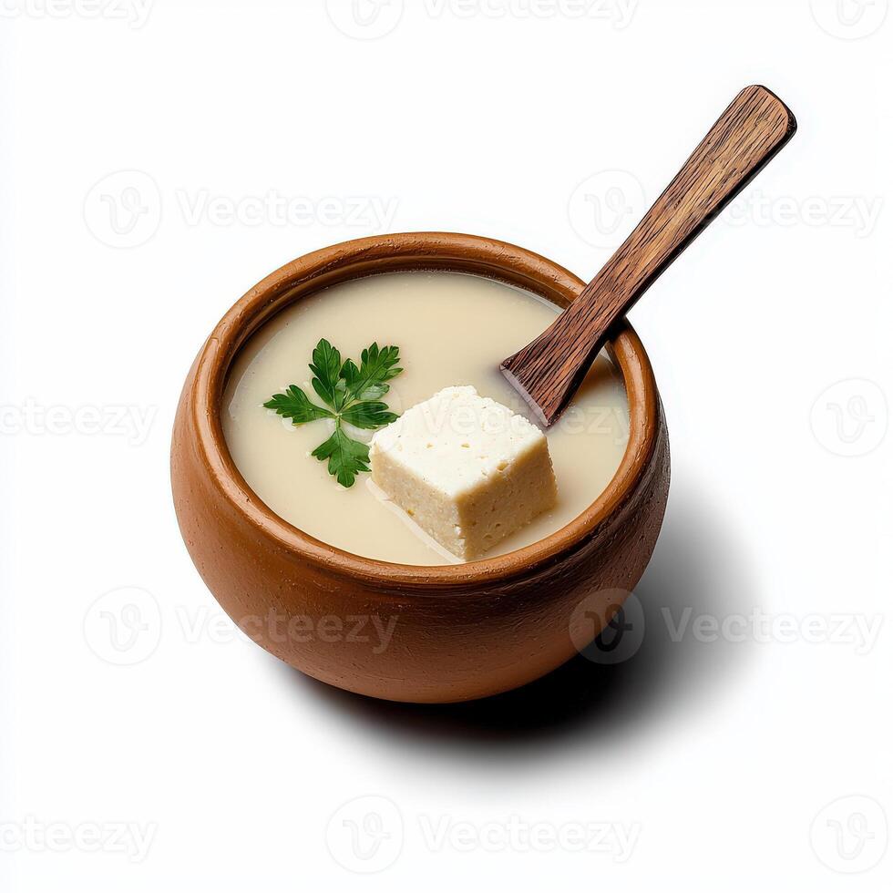 Tofu in a bowl with a spoon on a white background photo