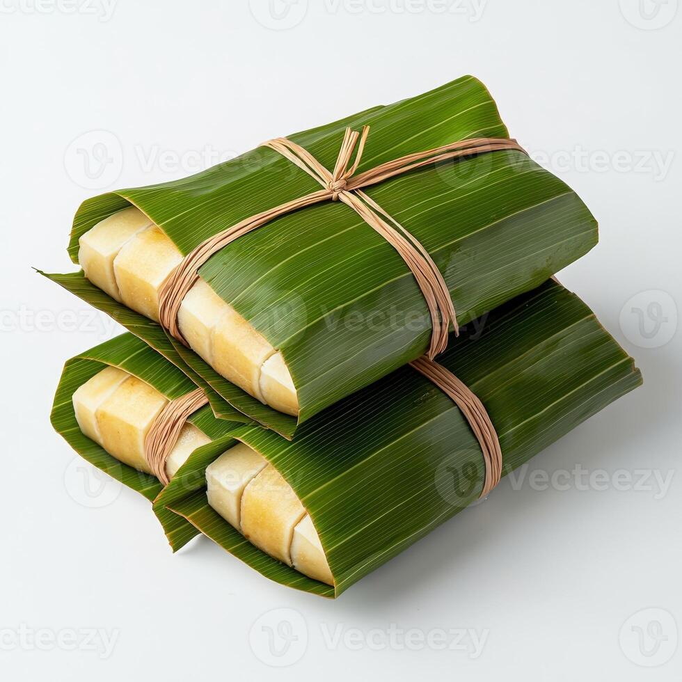 Three wrapped pieces of banana leaf wrapped in string photo