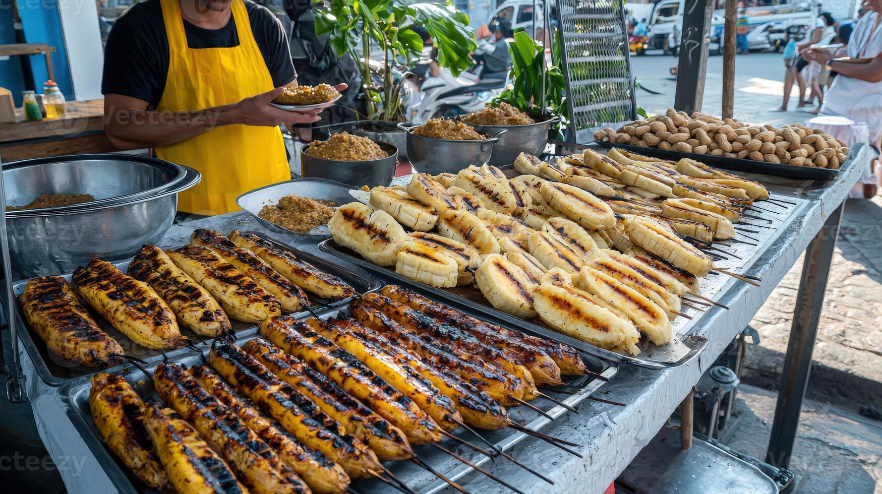 A man is standing in front of a grill with food photo