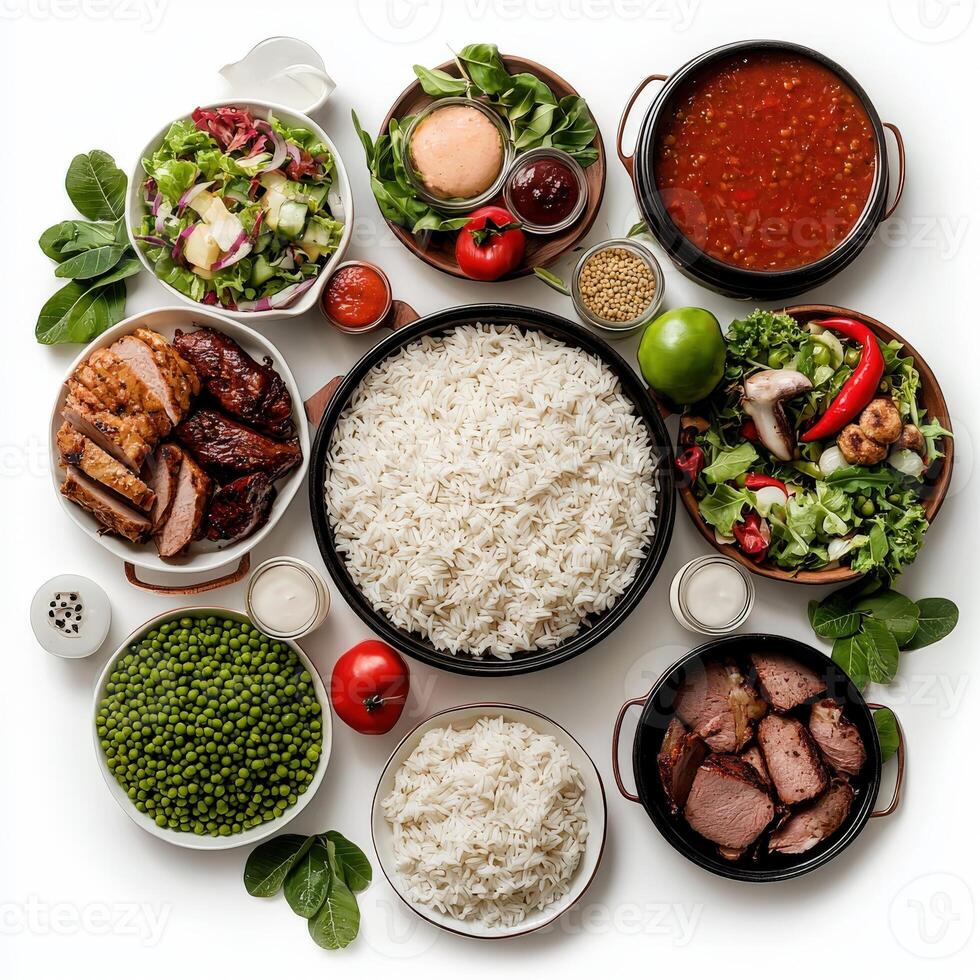 A variety of different types of food including rice, meat, vegetables and sauce photo