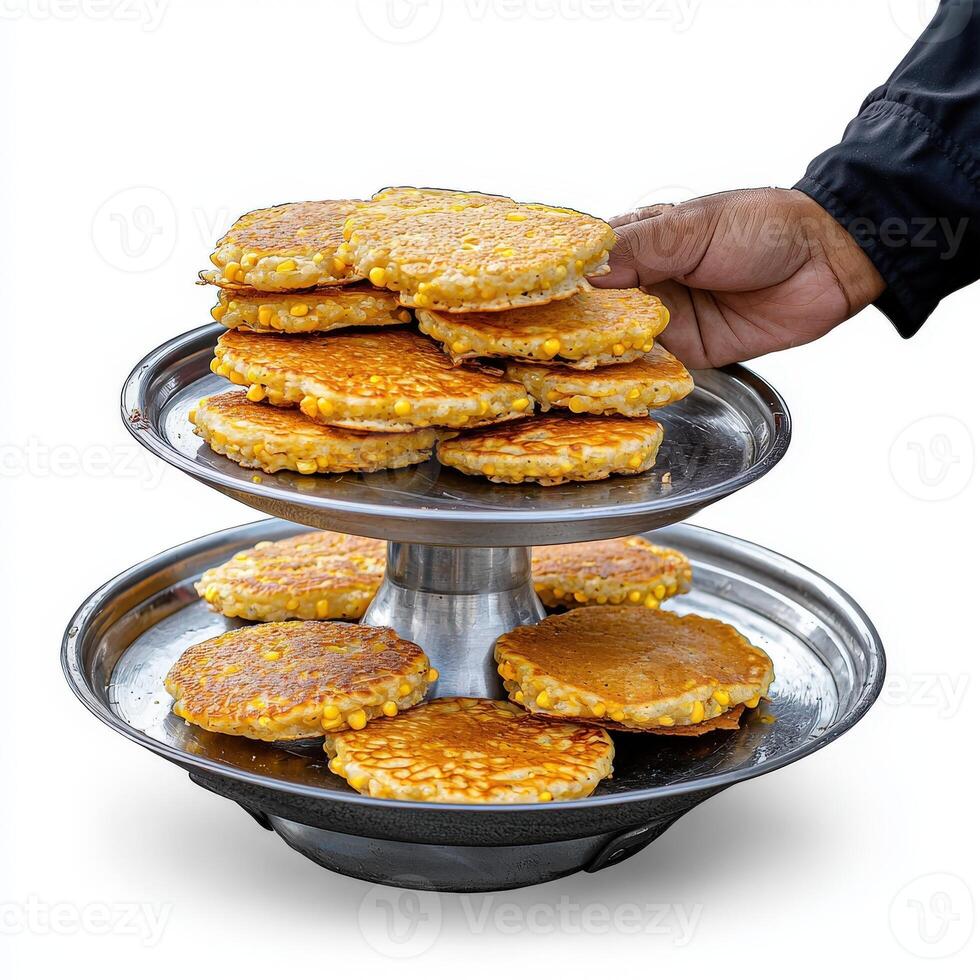 A person holding a stack of pancakes on a tray photo