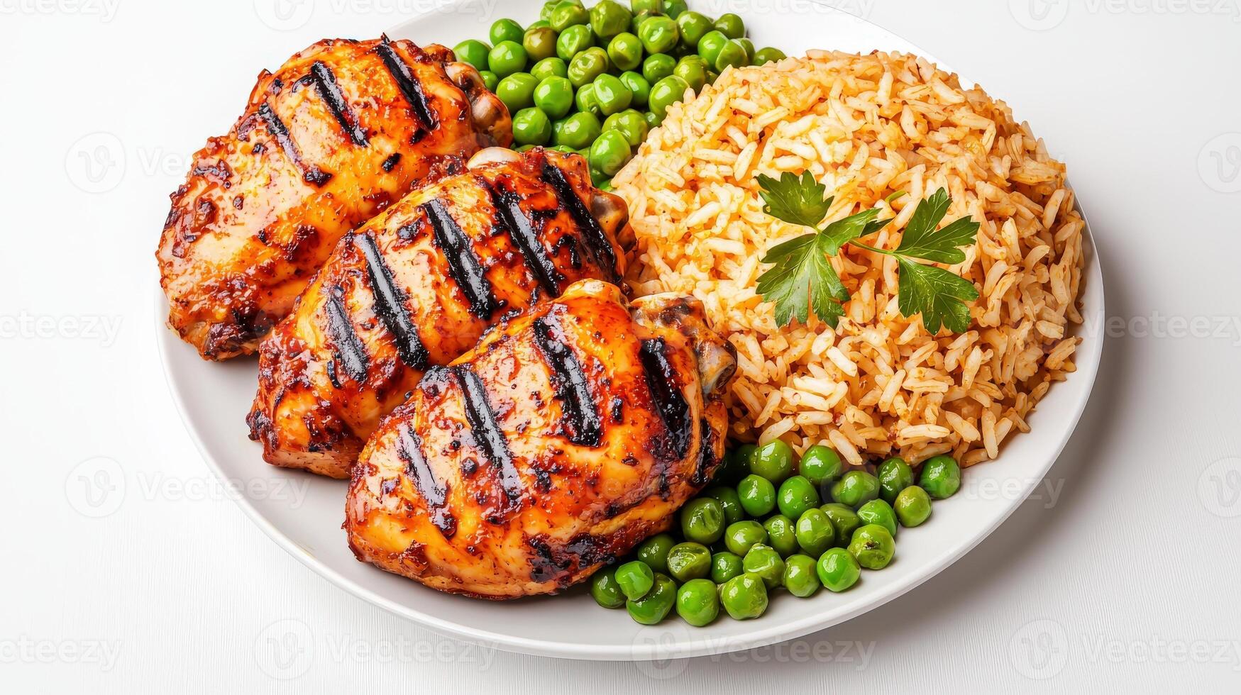 Grilled chicken with rice and peas on a white plate photo
