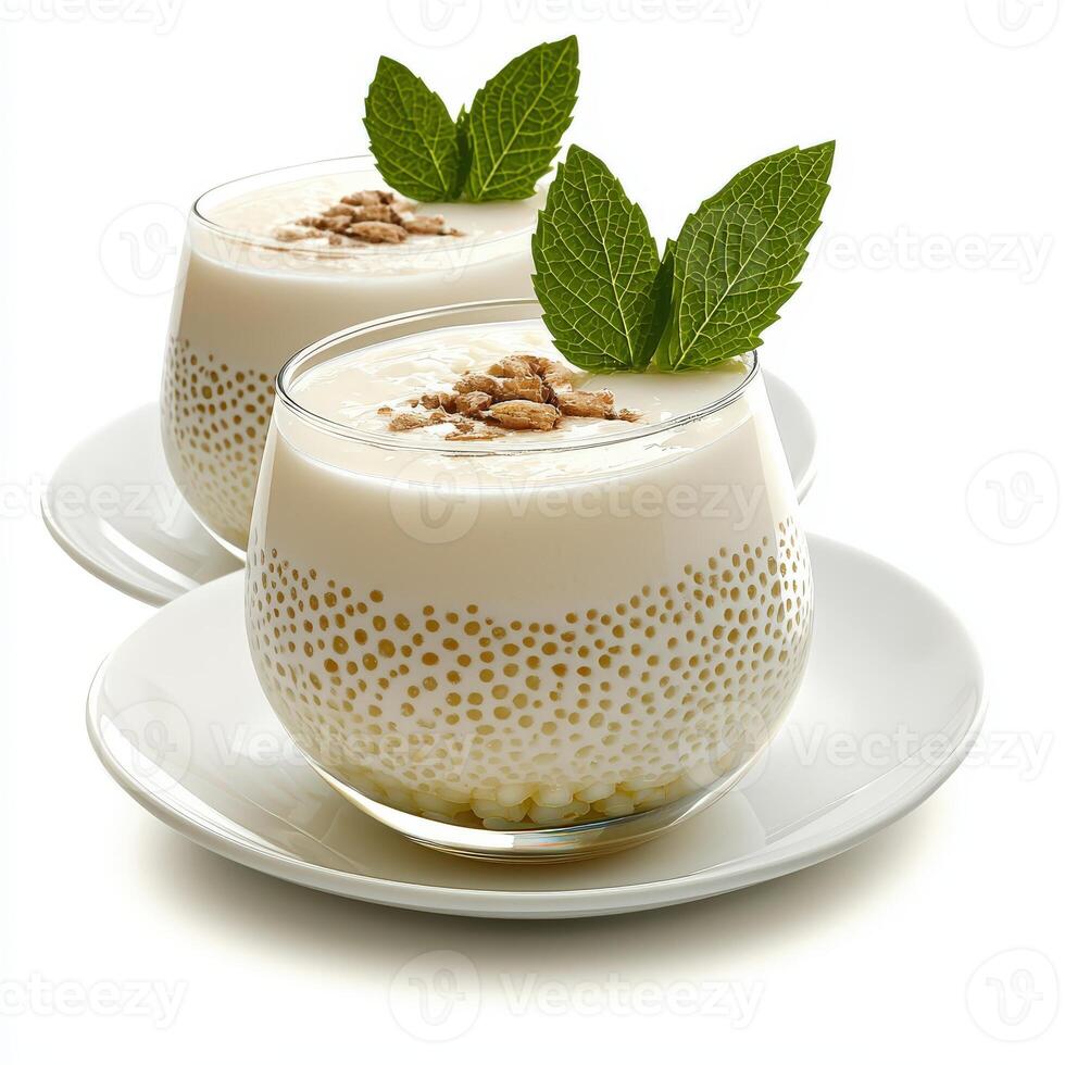 Two glasses of yogurt with almonds and mint leaves photo