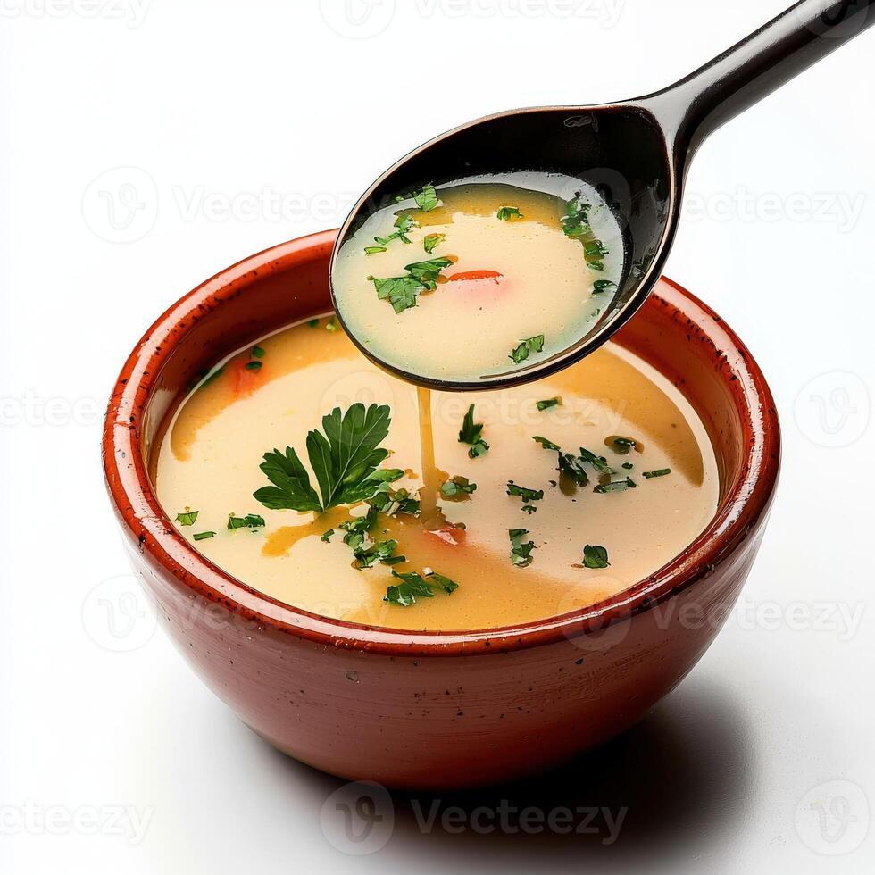 A bowl of soup with a spoon and a spoon photo