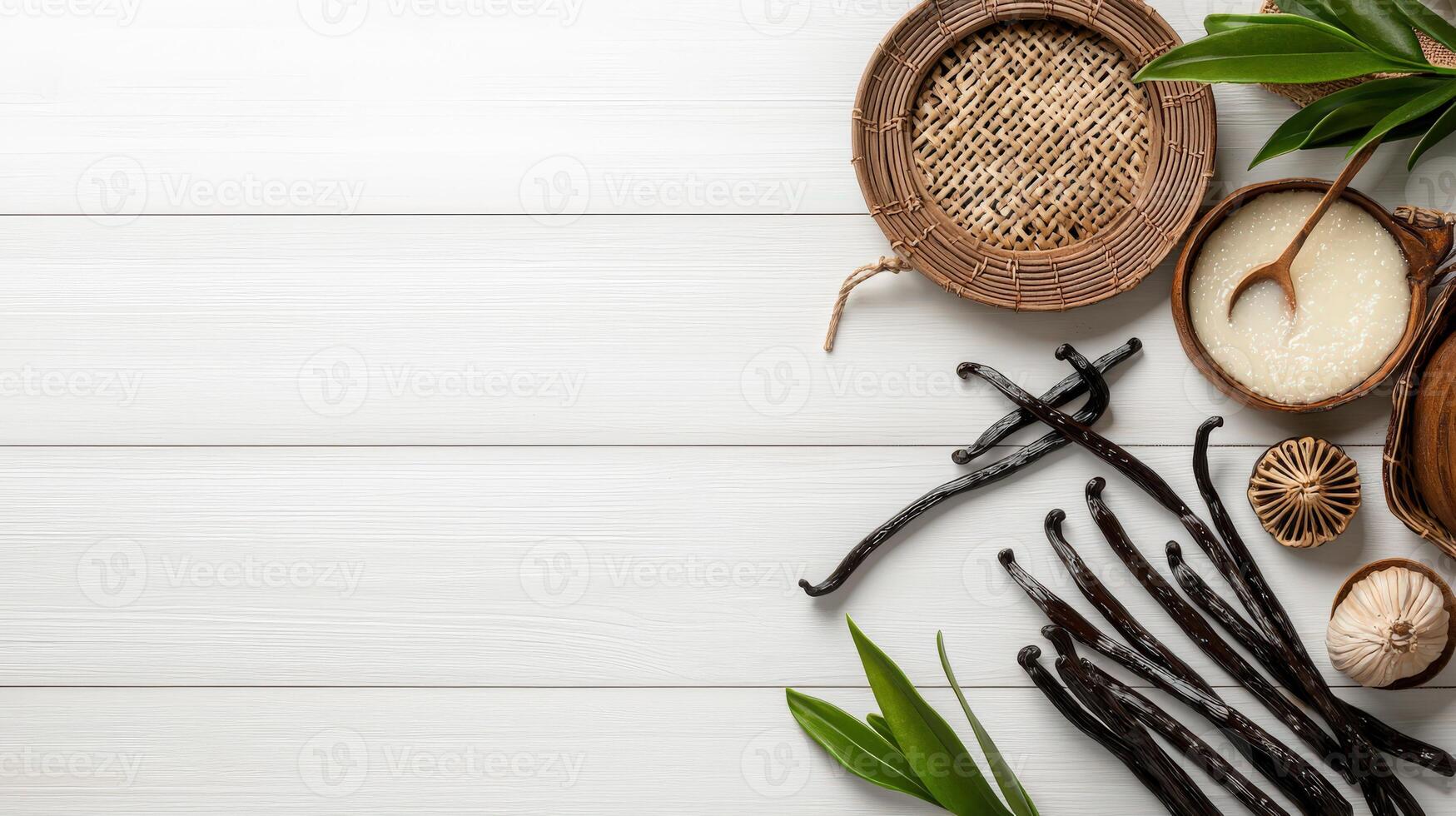 Various types of vanilla beans and other ingredients on a wooden table photo