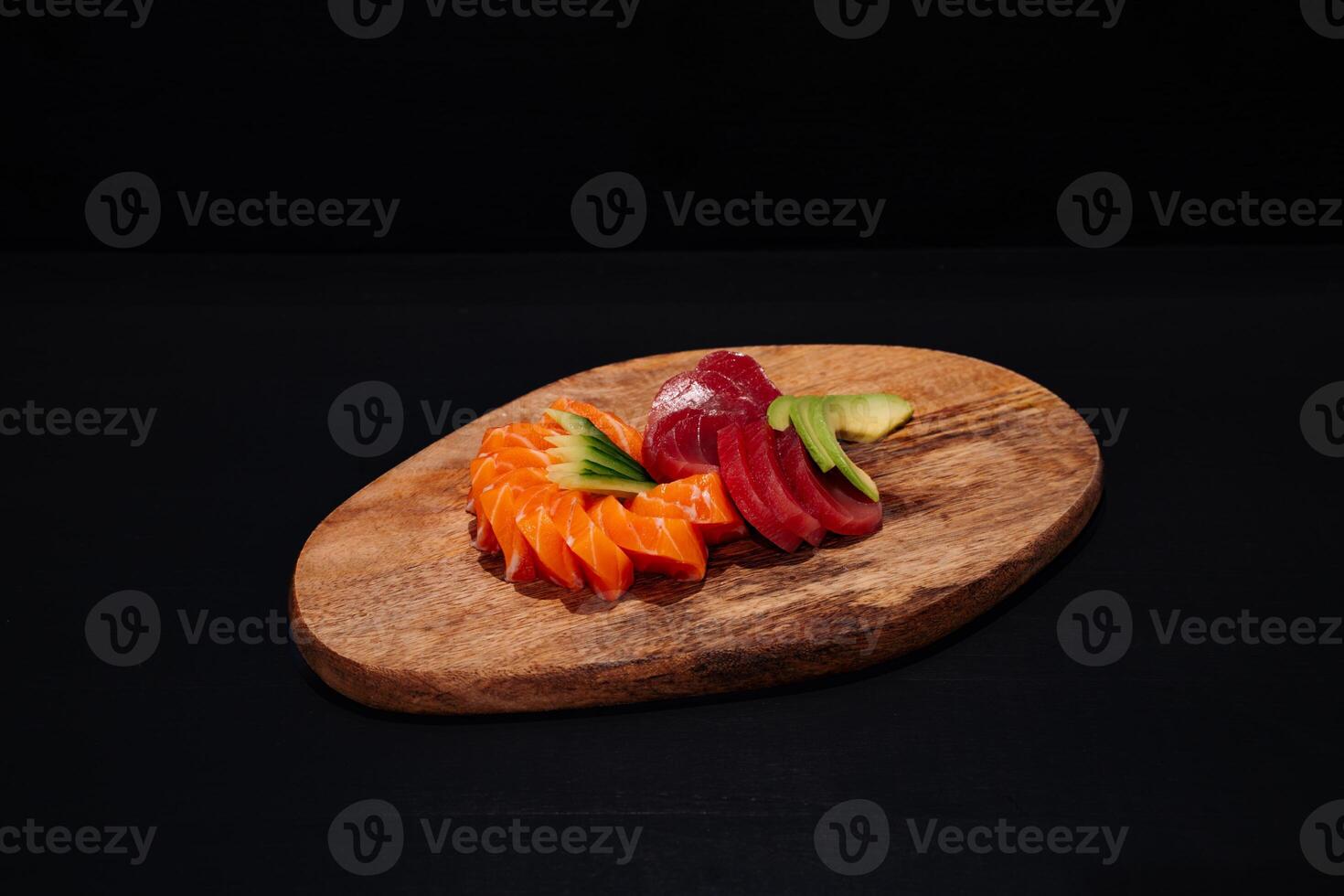 Creative minimalist display of assorted sashimi on a wooden platter against a dark backdrop, emphasizing vibrant colors and exquisite Japanese culinary art with a modern aesthetic. photo