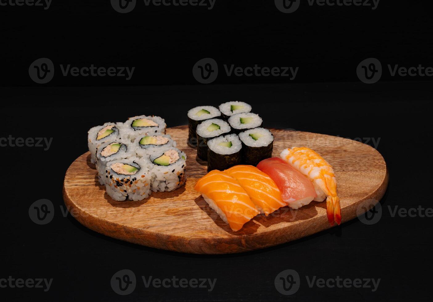 Wooden Platter With Assorted Sushi Rolls on Dark Background j photo