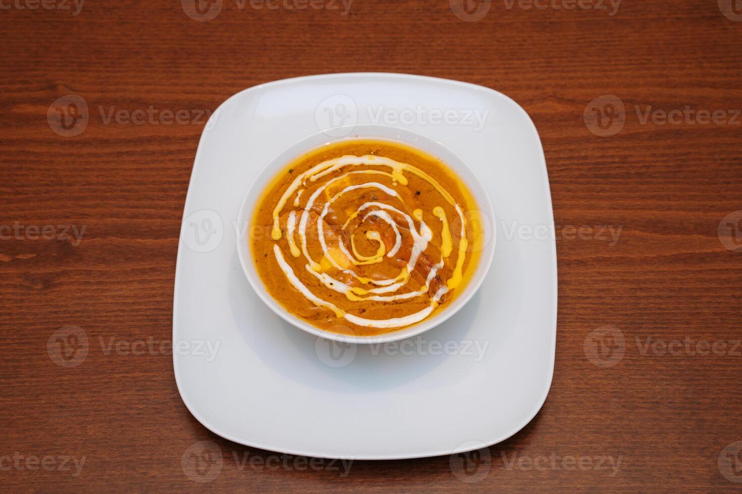 chicken korma in white plate. Delicious freshly prepared meal, perfect for menus, restaurants, or food delivery concepts. photo