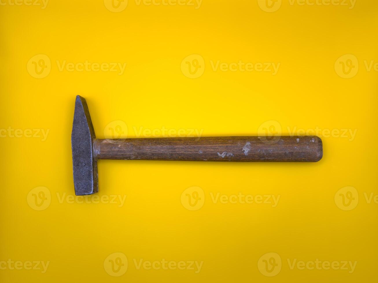 Rusty hammer on yellow background. Builder Tool. Flat lay. Top view, copy space. photo