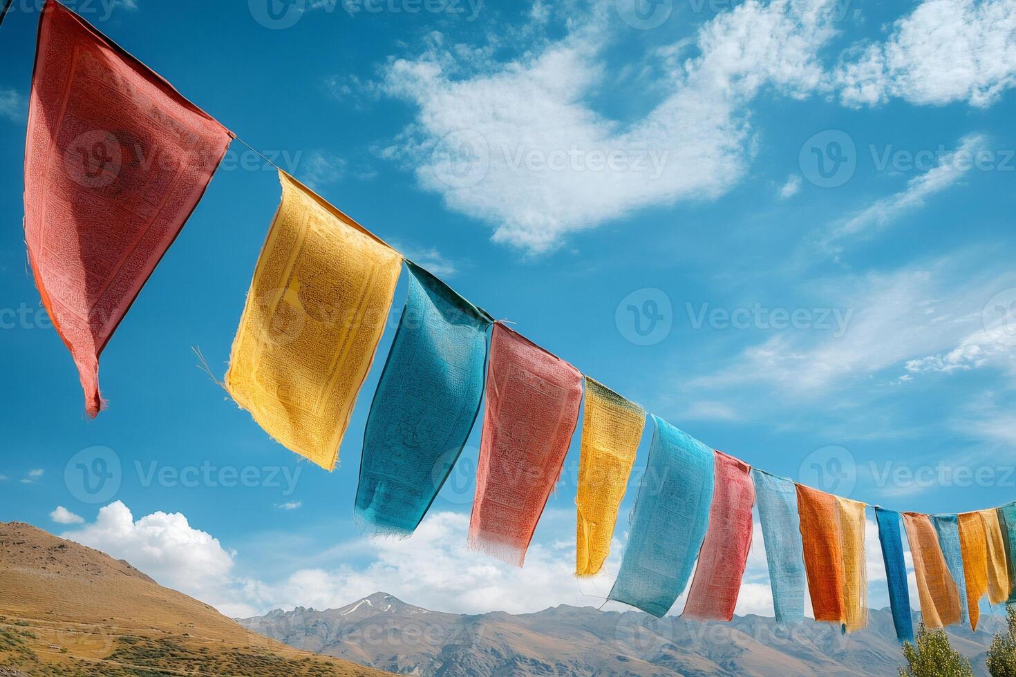 Colorful prayer flags waving in the wind over mountains in tibet photo