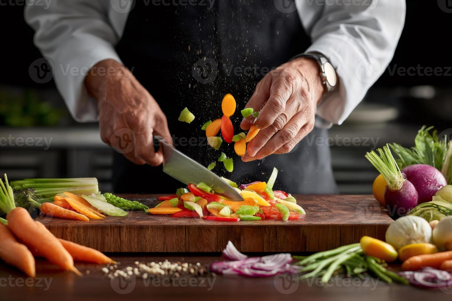 Chef adding chopped vegetables to a wooden cutting board photo
