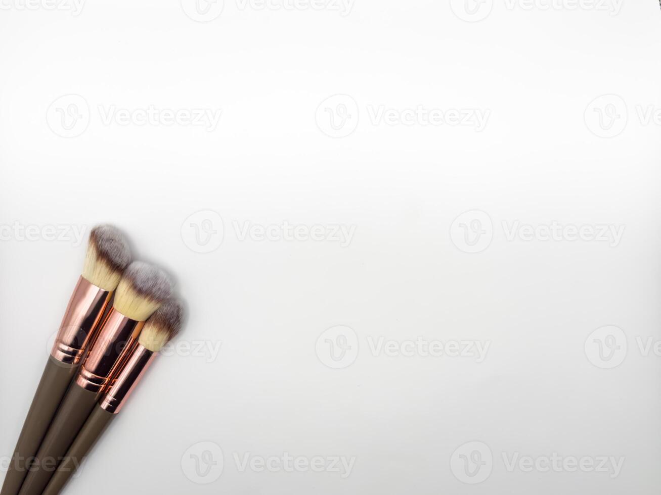 Three makeup brushes mermaid tail on a bright white background. copy space, flat lay, top view photo