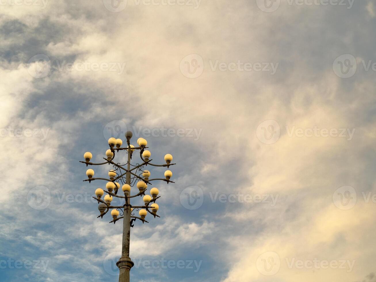 Street lamp post in the blue sky in the city and park photo