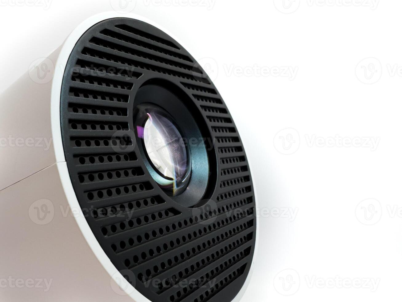 Clean projector lens macro close up view on white plastic body, copy space photo