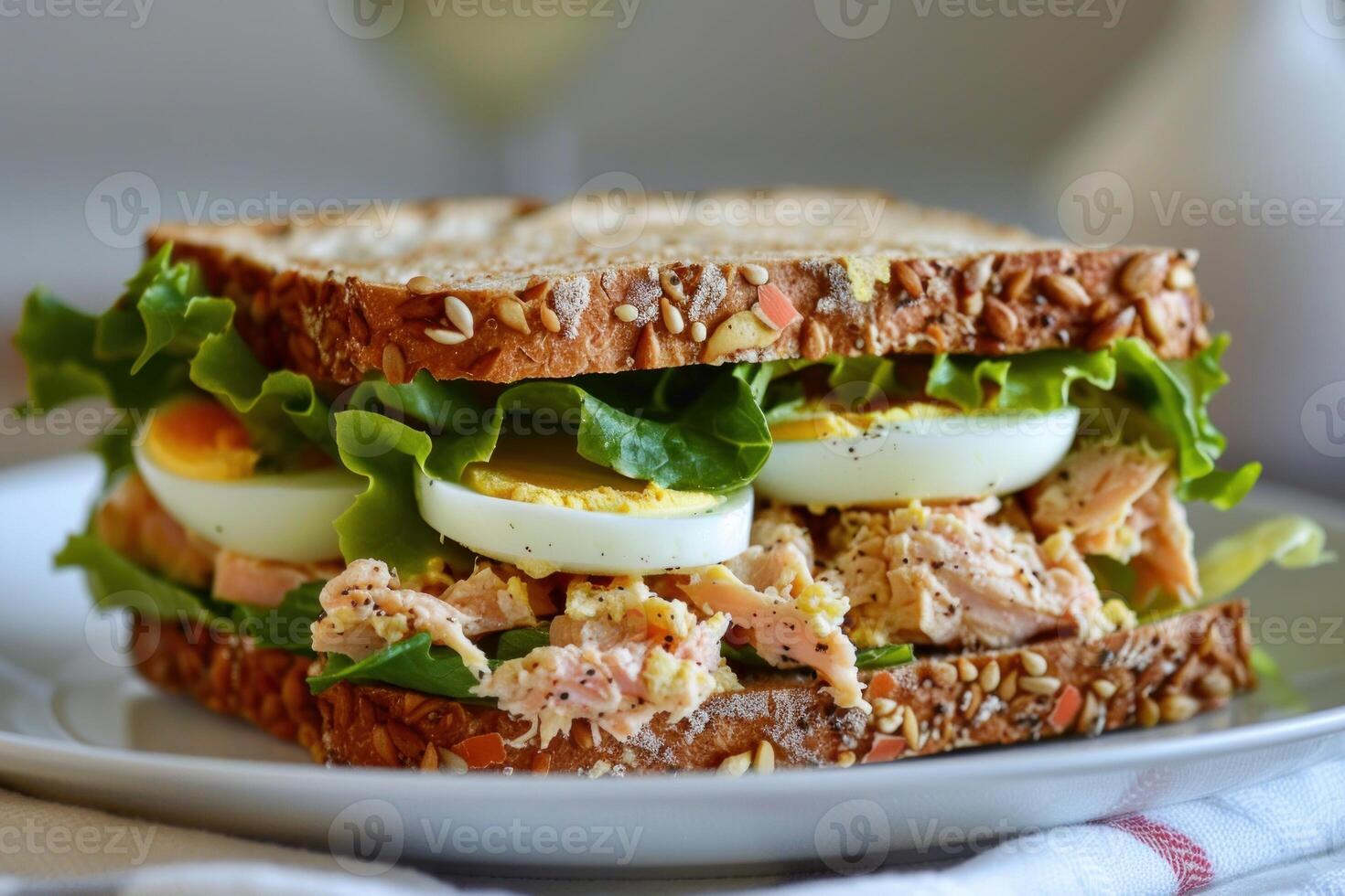 Tuna and egg salad sandwich with lettuce on whole wheat bread photo