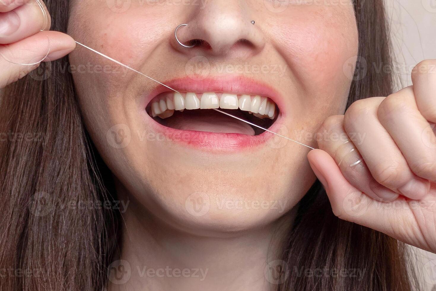 Woman uses dental floss, Close up photo
