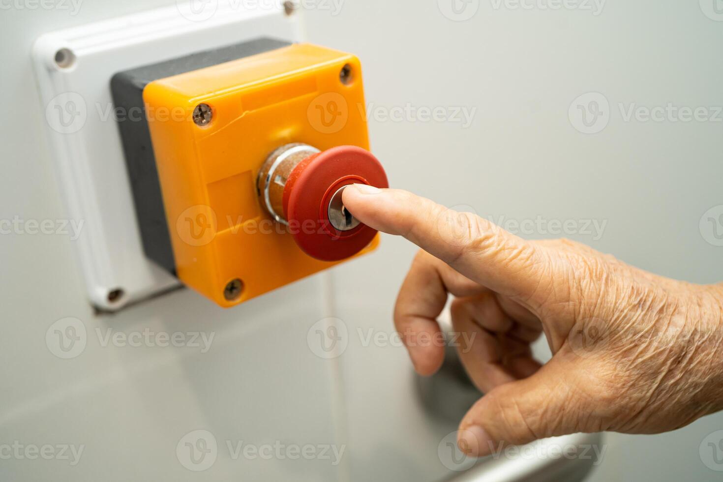 Asian elderly woman press emergency button in toilet. photo