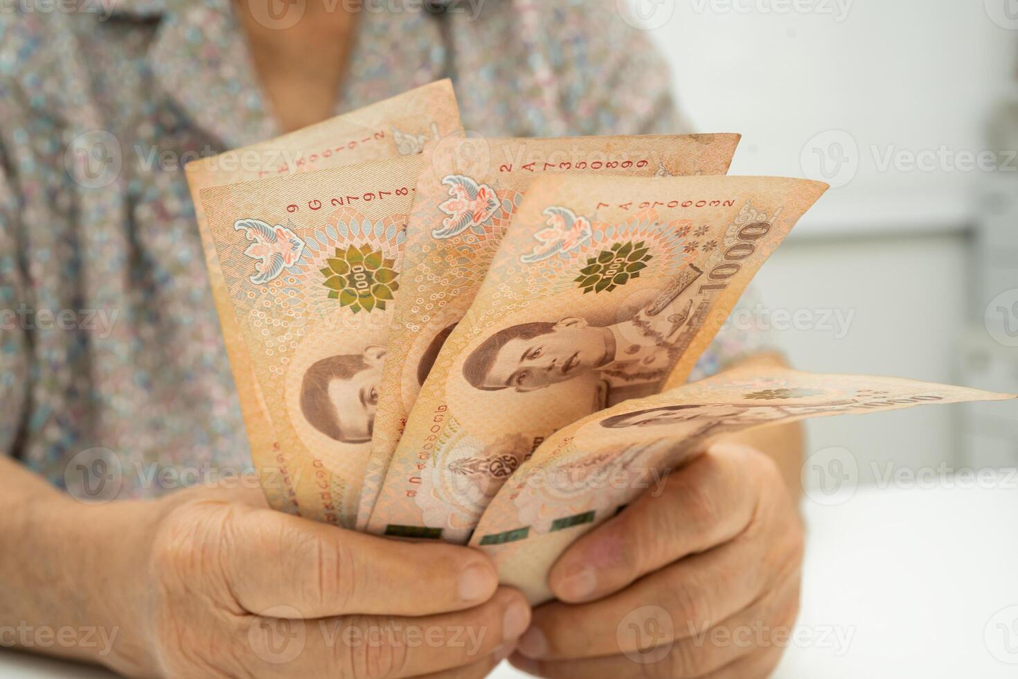 senior woman patient holding Thai banknotes money in her hand, Cost of living and medical care. photo