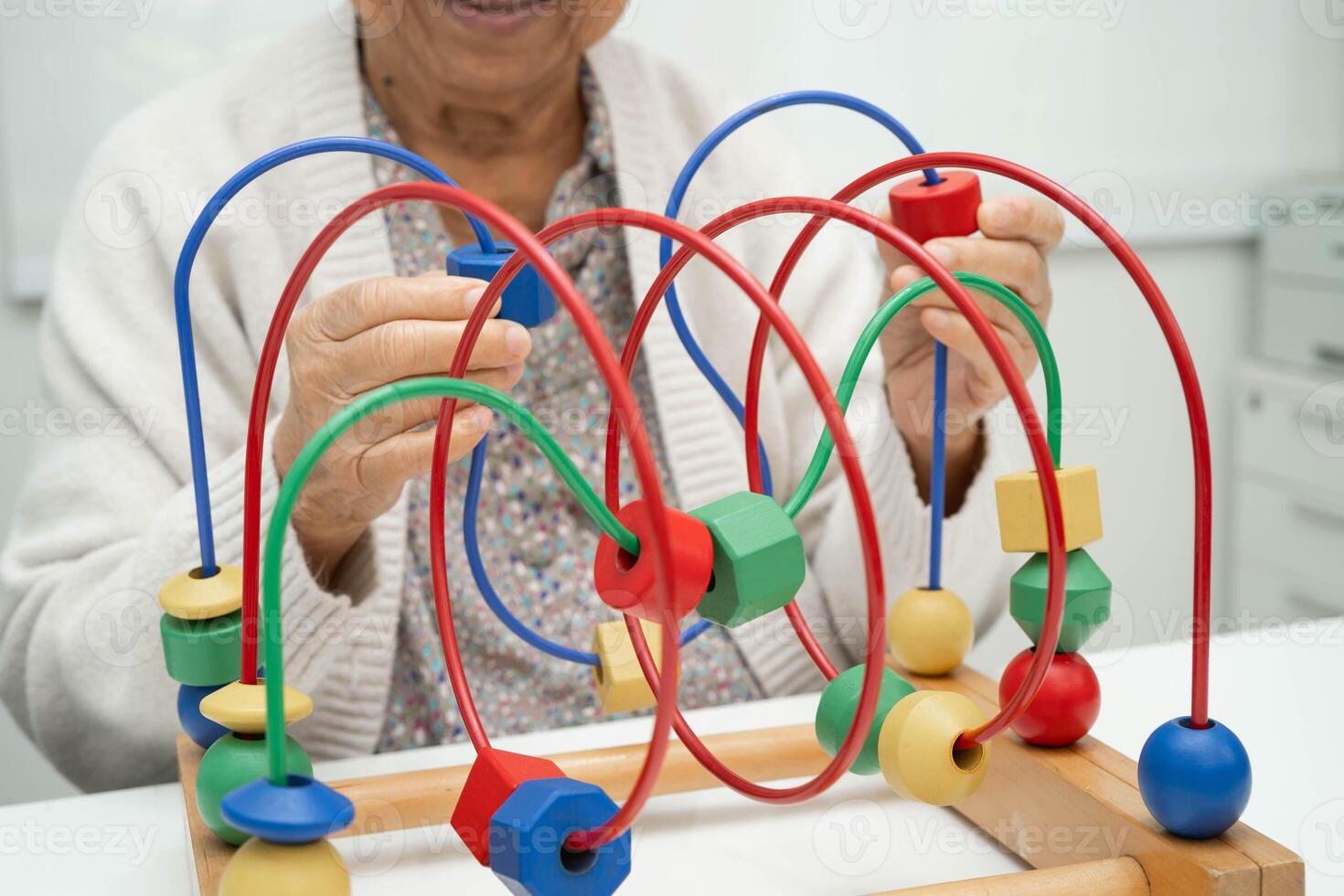 elderly woman playing enhancing skill board game. photo