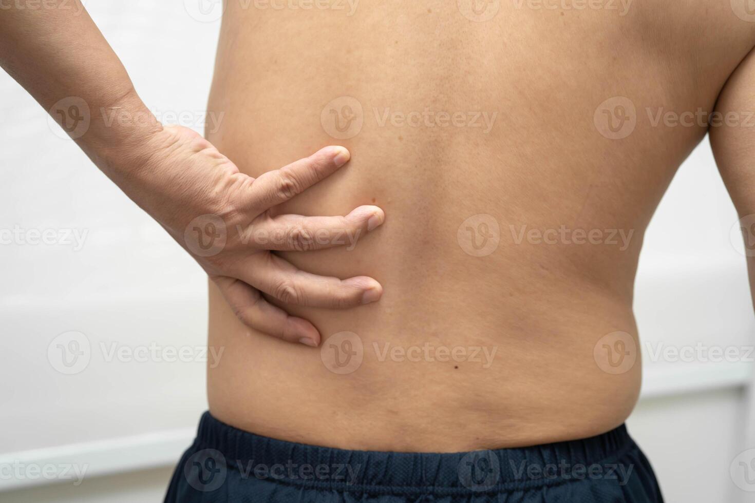 Asian man pain back muscle, spine and bone from accident. photo
