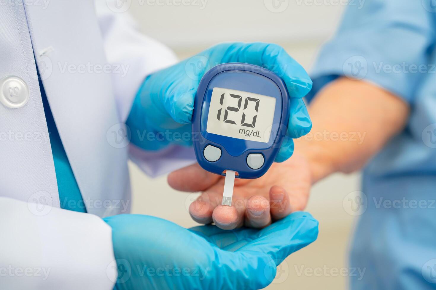 doctor using digital glucose meter for check sample blood sugar level photo